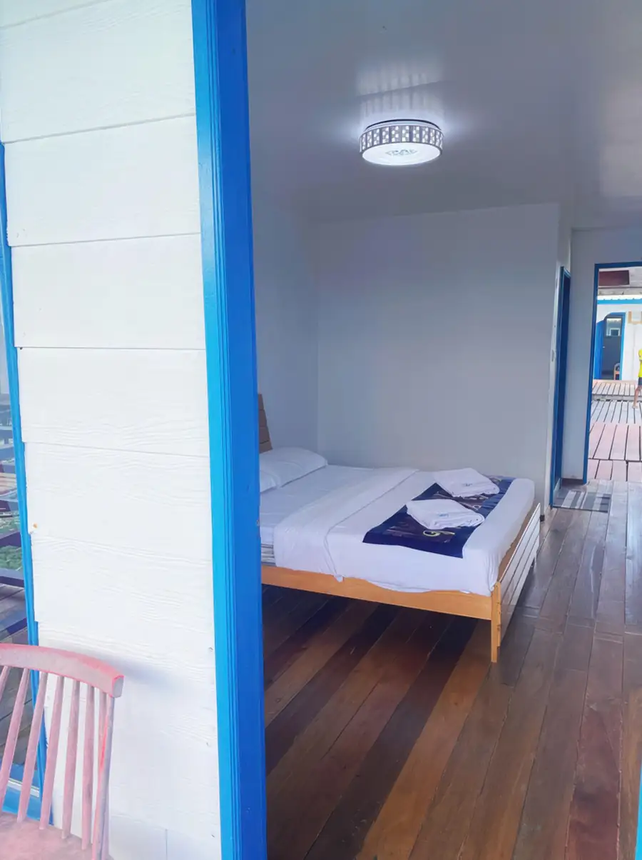 Traditional-style Deluxe Double Room at Amina Holidays with natural wood finishes