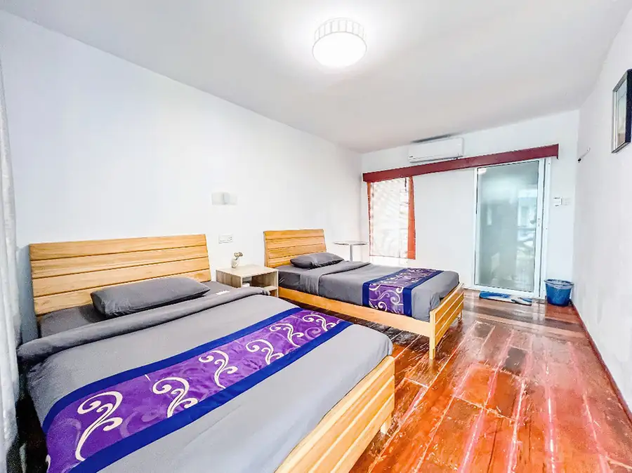 Airy interior of the Deluxe Twin Room at Amina Holidays overwater resort