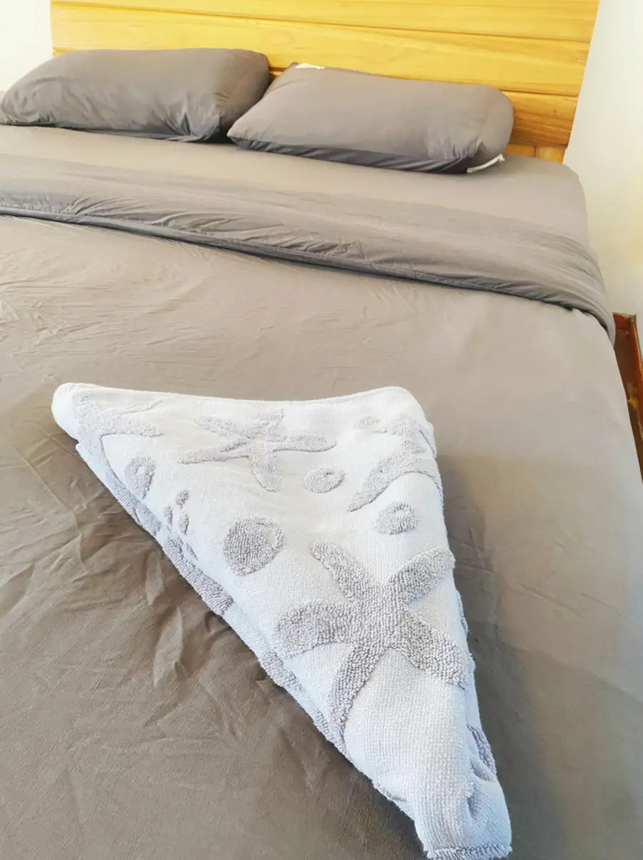 Starfish towel art on the beds in the Deluxe Twin Room at Amina Holidays