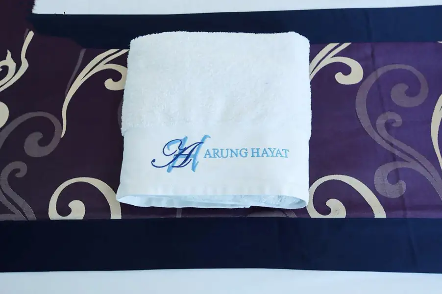 Twin bed details with white linen in the Deluxe Twin Room at Amina Holidays